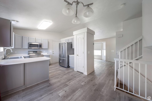 1454 N 420 E, Tooele, UT 84074 - kitchen with stainless steel appliances, a sink, lofted ceiling, light countertops, and light wood-type flooring
