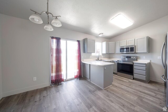 1454 N 420 E, Tooele, UT 84074 - kitchen featuring appliances with stainless steel finishes, a peninsula, gray cabinets, light countertops, and a sink