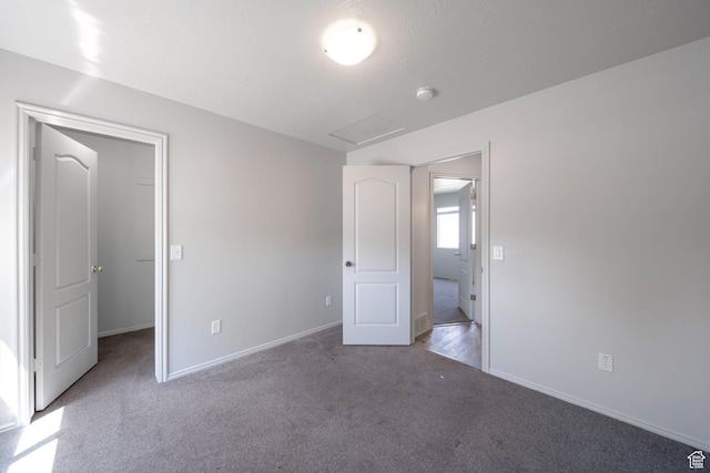 1454 N 420 E, Tooele, UT 84074 - unfurnished bedroom featuring carpet, a spacious closet, baseboards, and attic access