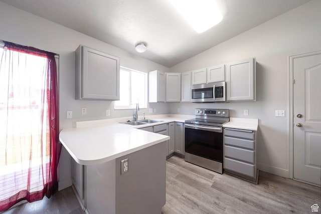 1454 N 420 E, Tooele, UT 84074 - kitchen with appliances with stainless steel finishes, a sink, gray cabinets, a peninsula, and vaulted ceiling