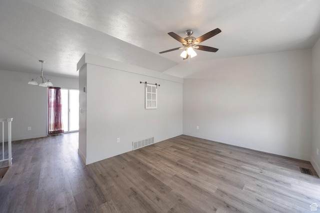 1454 N 420 E, Tooele, UT 84074 - spare room featuring a ceiling fan, wood finished floors, a chandelier, and baseboards
