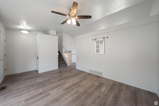 1454 N 420 E, Tooele, UT 84074 - unfurnished room featuring ceiling fan, stairs, wood finished floors, baseboards, and lofted ceiling