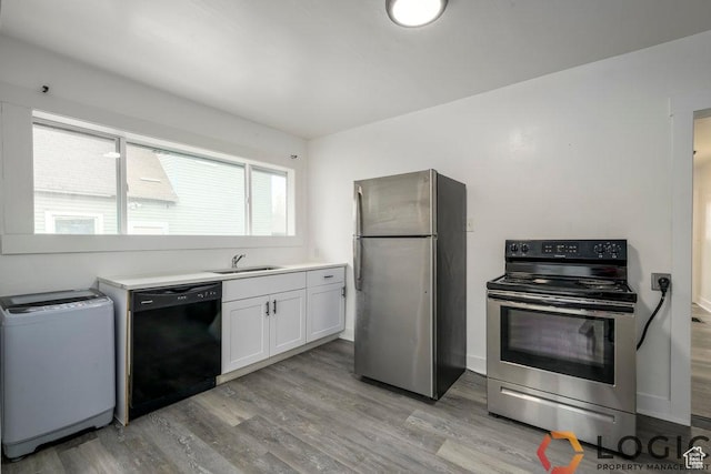 2743 Liberty Ave, Ogden, UT 84403 - kitchen with stainless steel appliances, light wood-style flooring, white cabinetry, a sink, and light countertops