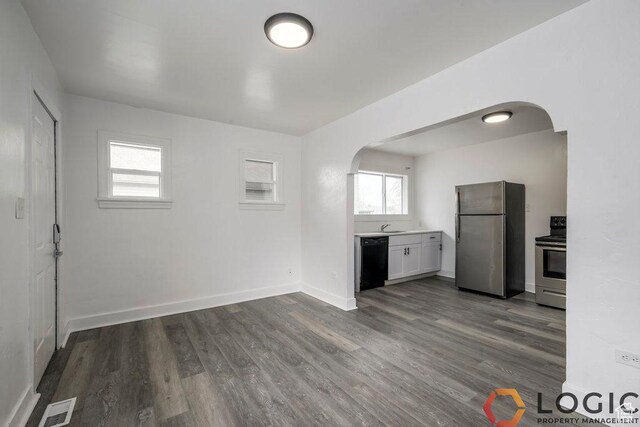 2743 Liberty Ave, Ogden, UT 84403 - kitchen with stainless steel appliances, arched walkways, dark wood-style flooring, and a sink