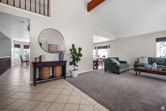 10128 S 2460 E, Sandy, UT 84092 - living area with high vaulted ceiling, plenty of natural light, beam ceiling, baseboards, and light tile patterned floors