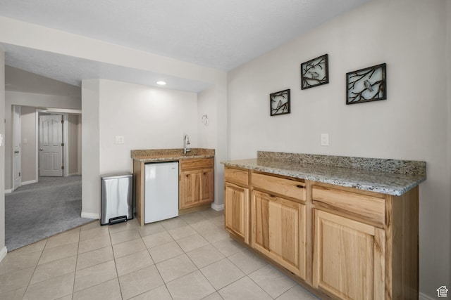 10128 S 2460 E, Sandy, UT 84092 - kitchen featuring baseboards, a sink, light tile patterned floors, light stone countertops, and recessed lighting
