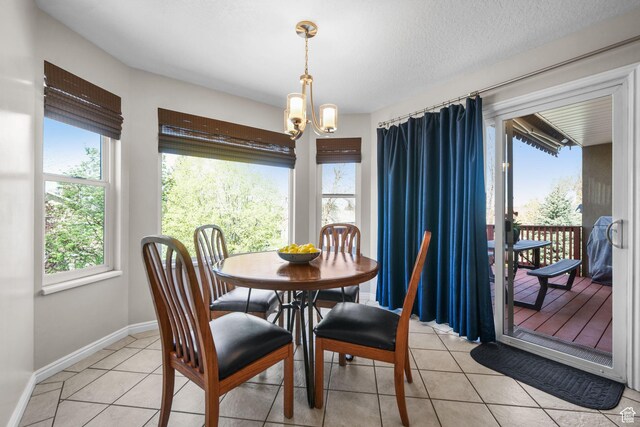 10128 S 2460 E, Sandy, UT 84092 - dining space featuring a chandelier, light tile patterned floors, and baseboards