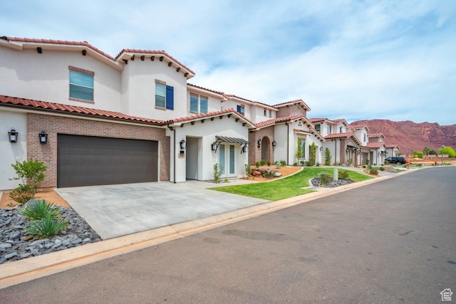 3780 Arcadia Dr Unit 53, Santa Clara, UT 84765 - mediterranean / spanish-style house featuring a tiled roof, an attached garage, stucco siding, and concrete driveway