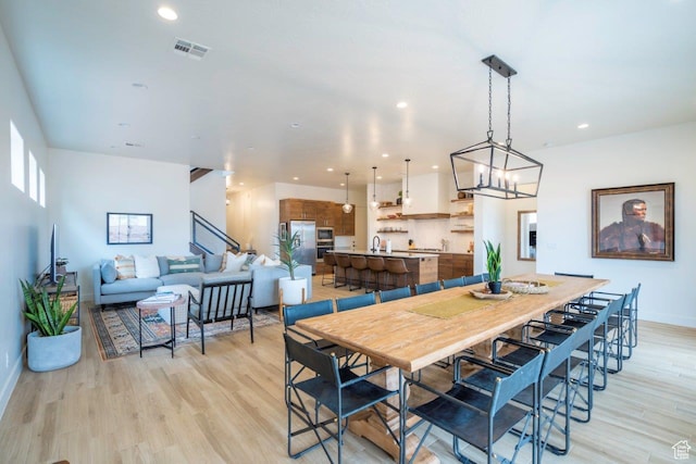 3780 Arcadia Dr Unit 53, Santa Clara, UT 84765 - dining area featuring light wood finished floors, a chandelier, baseboards, stairs, and recessed lighting