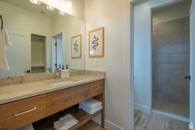 3780 Arcadia Dr Unit 53, Santa Clara, UT 84765 - bathroom with vanity, baseboards, a walk in shower, and wood finished floors