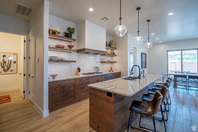 3780 Arcadia Dr Unit 53, Santa Clara, UT 84765 - kitchen featuring open shelves, a sink, light wood-style floors, tasteful backsplash, and recessed lighting