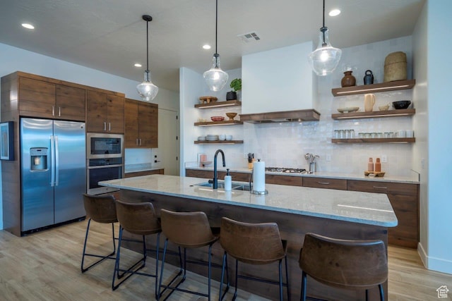 3780 Arcadia Dr Unit 53, Santa Clara, UT 84765 - kitchen with appliances with stainless steel finishes, open shelves, a sink, custom exhaust hood, and light wood-type flooring
