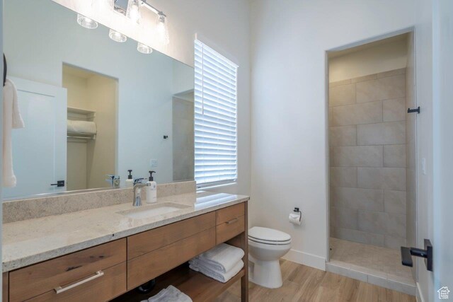 3780 Arcadia Dr Unit 53, Santa Clara, UT 84765 - full bath with vanity, toilet, tiled shower, wood finished floors, and healthy amount of natural light