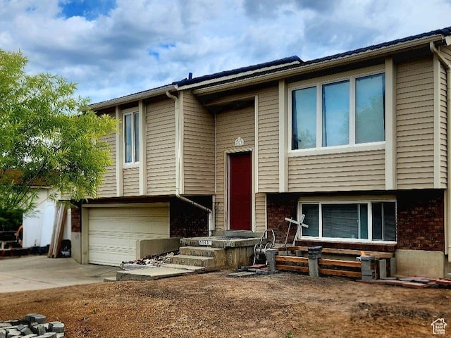 5649 S Bree St W, Taylorsville, UT 84129 - raised ranch with driveway, an attached garage, and brick siding