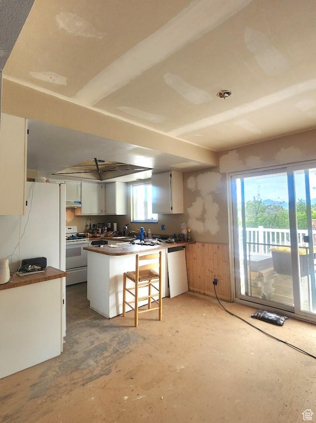 5649 S Bree St W, Taylorsville, UT 84129 - kitchen with white electric range, dishwashing machine, a peninsula, dark countertops, and a wainscoted wall