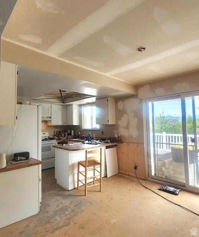 5649 S Bree St W, Taylorsville, UT 84129 - kitchen featuring white electric range oven, dishwasher, a wainscoted wall, a peninsula, and dark countertops