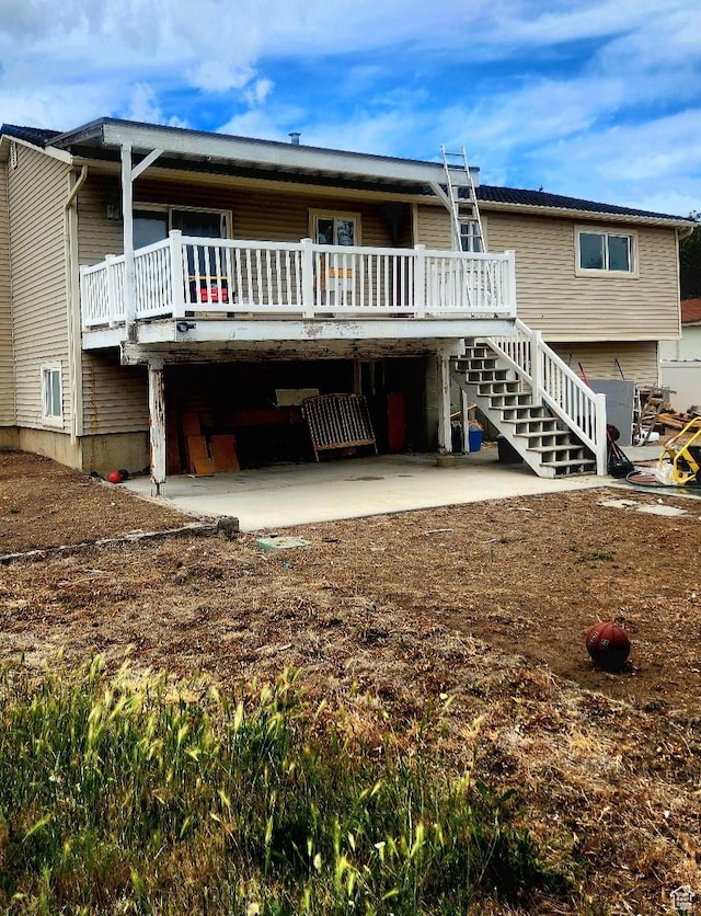 5649 S Bree St W, Taylorsville, UT 84129 - rear view of house with a patio, stairs, and a deck
