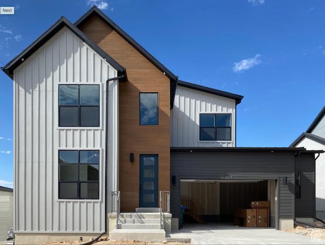 1594 W Canyon Rim N Unit 609, Lehi, UT 84043 - view of front of property featuring board and batten siding, concrete driveway, and an attached garage