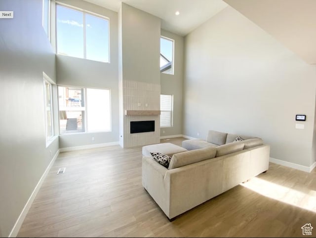1594 W Canyon Rim N Unit 609, Lehi, UT 84043 - living area featuring high vaulted ceiling, light wood-type flooring, baseboards, and a fireplace