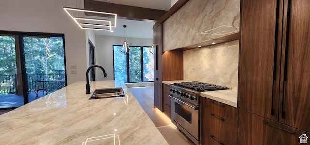 101 Crestview Cir, Park City, UT 84098 - kitchen with high end stainless steel range, a sink, light stone counters, backsplash, and modern cabinets