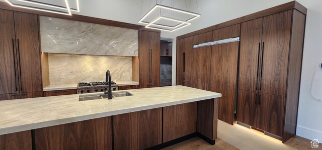 101 Crestview Cir, Park City, UT 84098 - kitchen with decorative backsplash, a sink, and light wood finished floors