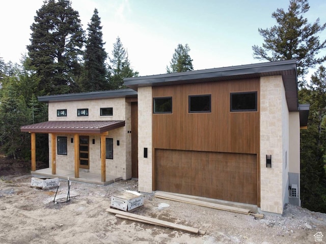 101 Crestview Cir, Park City, UT 84098 - view of front of home with stone siding, driveway, a standing seam roof, and metal roof