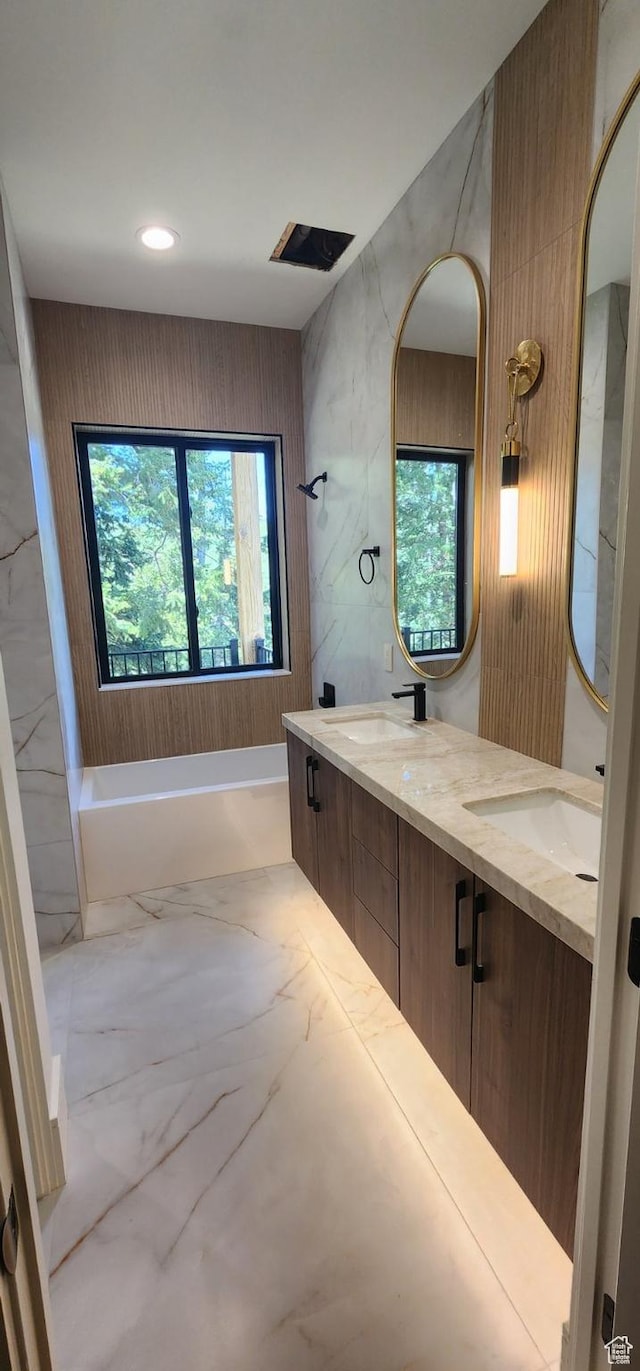 101 Crestview Cir, Park City, UT 84098 - bathroom featuring marble look tiles, a bathtub, double vanity, and recessed lighting