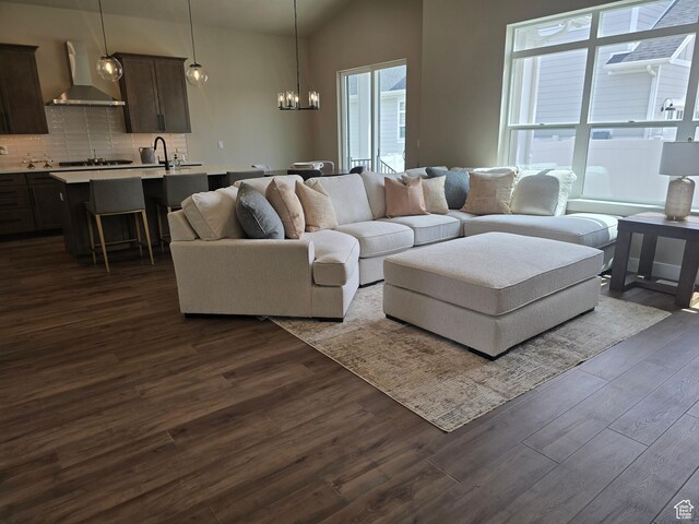 3577 W Haven Hollow Dr S, South Jordan, UT 84095 - living room featuring a chandelier, dark wood finished floors, and lofted ceiling
