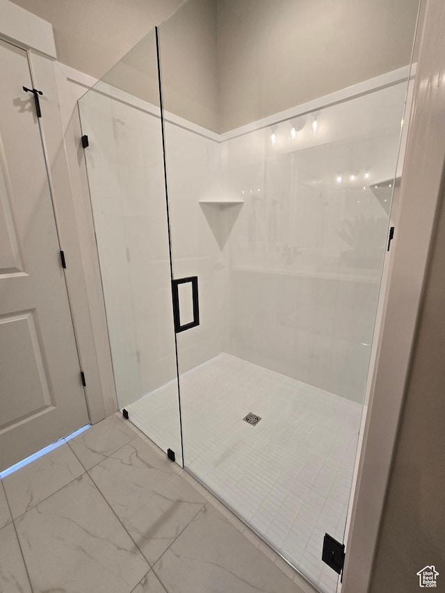 3577 W Haven Hollow Dr S, South Jordan, UT 84095 - bathroom featuring marble look tile flooring and a stall shower