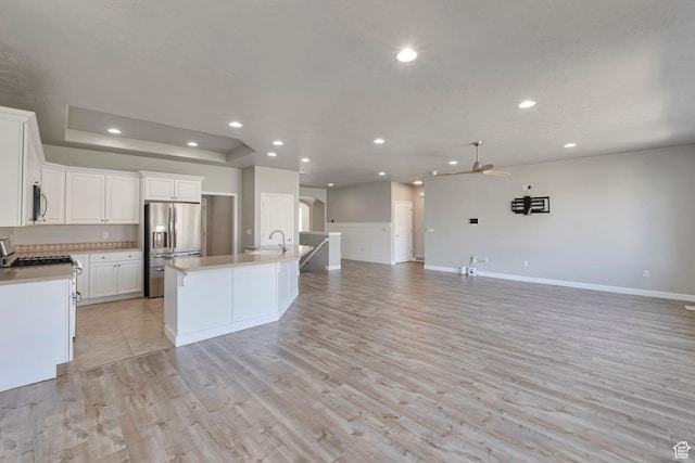 2832 N Turnberry Ln, Lehi, UT 84043 - kitchen featuring appliances with stainless steel finishes, open floor plan, a ceiling fan, a sink, and light countertops