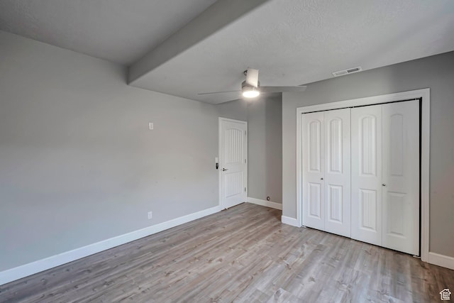 2832 N Turnberry Ln, Lehi, UT 84043 - unfurnished bedroom with wood finished floors, baseboards, a closet, a ceiling fan, and a textured ceiling