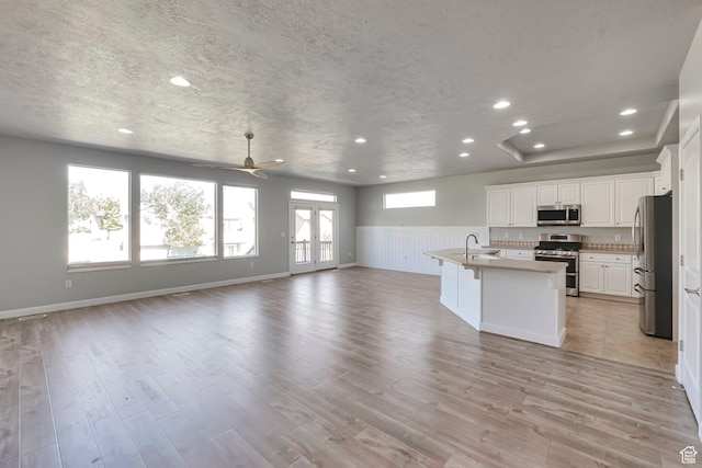 2832 N Turnberry Ln, Lehi, UT 84043 - kitchen with appliances with stainless steel finishes, open floor plan, recessed lighting, white cabinetry, and light wood-style floors
