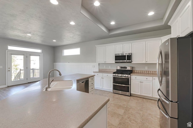 2832 N Turnberry Ln, Lehi, UT 84043 - kitchen featuring appliances with stainless steel finishes, a sink, white cabinetry, a wainscoted wall, and recessed lighting