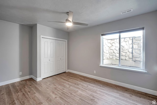 2832 N Turnberry Ln, Lehi, UT 84043 - unfurnished bedroom with wood finished floors, baseboards, a closet, a textured ceiling, and a ceiling fan