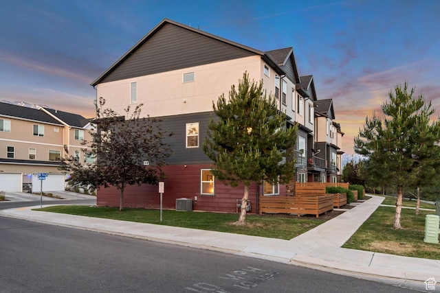 1791 W 60 S, Pleasant Grove, UT 84062 - property exterior at dusk with central AC unit and a lawn