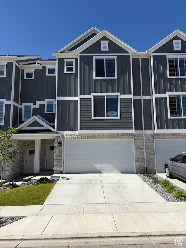 964 W Shadow Brook Ln, Lehi, UT 84043 - view of front facade with stone siding, a garage, concrete driveway, and board and batten siding