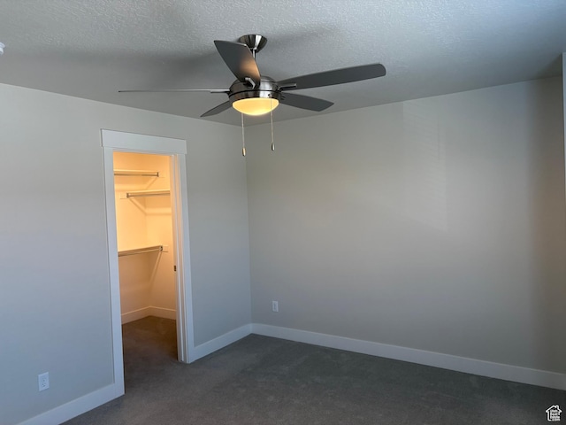 964 W Shadow Brook Ln, Lehi, UT 84043 - unfurnished bedroom featuring a spacious closet, dark colored carpet, a textured ceiling, baseboards, and ceiling fan
