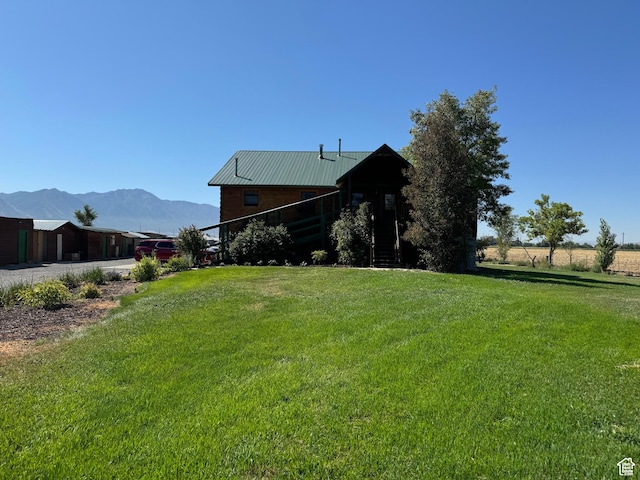 1777 W Palmyra Dr, Palmyra, UT 84660 - view of front of home with a front yard, a mountain view, and metal roof