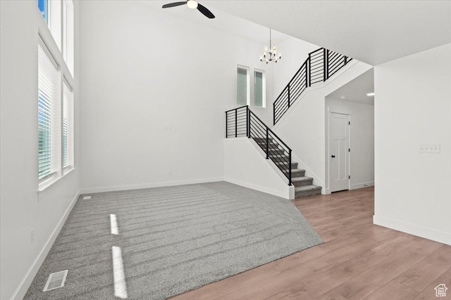 12361 S Xander Ln, Herriman, UT 84096 - foyer with baseboards, stairs, a ceiling fan, a chandelier, and a towering ceiling