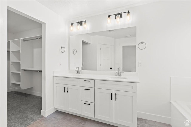 12361 S Xander Ln, Herriman, UT 84096 - bathroom featuring double vanity, baseboards, a tub, and a closet