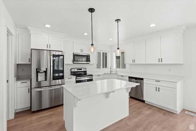 12361 S Xander Ln, Herriman, UT 84096 - kitchen with appliances with stainless steel finishes, a sink, light wood-style flooring, recessed lighting, and white cabinets