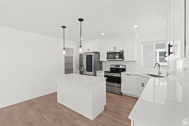 12361 S Xander Ln, Herriman, UT 84096 - kitchen featuring stainless steel appliances, a sink, a kitchen island, white cabinets, and recessed lighting