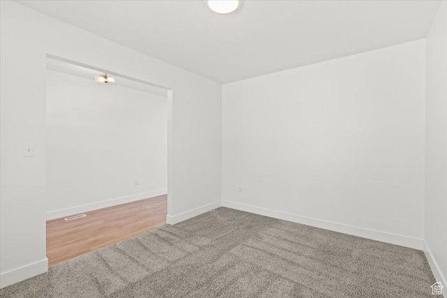 12361 S Xander Ln, Herriman, UT 84096 - spare room featuring baseboards, carpet flooring, and wood finished floors