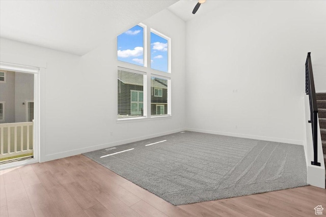 12361 S Xander Ln, Herriman, UT 84096 - unfurnished room featuring wood finished floors, ceiling fan, baseboards, and vaulted ceiling