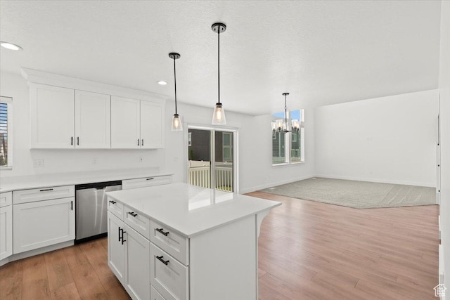 12361 S Xander Ln, Herriman, UT 84096 - kitchen featuring stainless steel dishwasher, a chandelier, open floor plan, light wood-style flooring, and light countertops