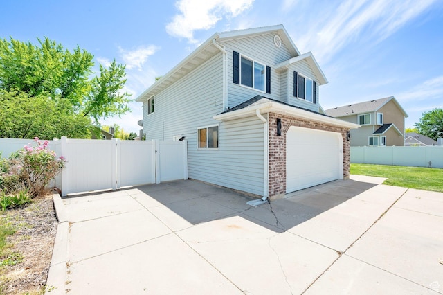 524 E 1200 S, Kaysville, UT 84037 - view of side of home featuring an attached garage, driveway, a gate, and brick siding