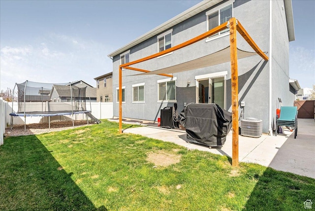 204 E 460 N, Vineyard, UT 84059 - rear view of property featuring a trampoline, a patio area, stucco siding, and cooling unit