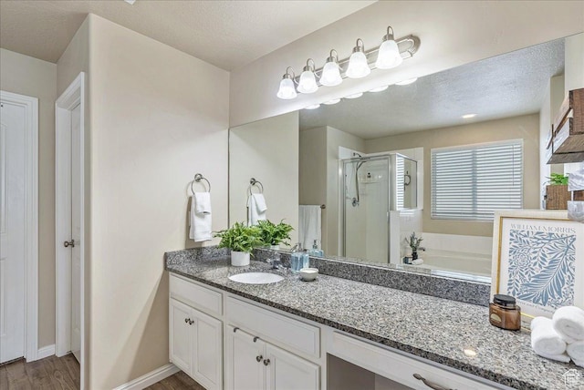 204 E 460 N, Vineyard, UT 84059 - bathroom featuring a shower stall, vanity, a garden tub, wood finished floors, and baseboards