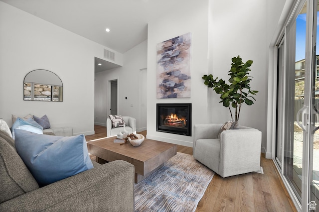 5472 N Valley View Rd W, Lehi, UT 84043 - living area with wood finished floors, a glass covered fireplace, baseboards, and recessed lighting