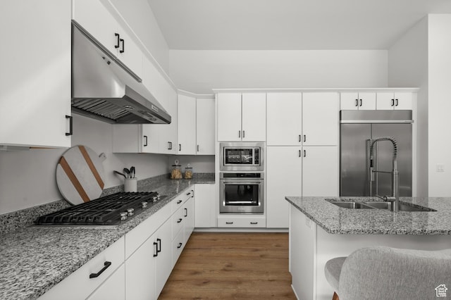 5472 N Valley View Rd W, Lehi, UT 84043 - kitchen featuring stainless steel appliances, under cabinet range hood, wood finished floors, and light stone counters